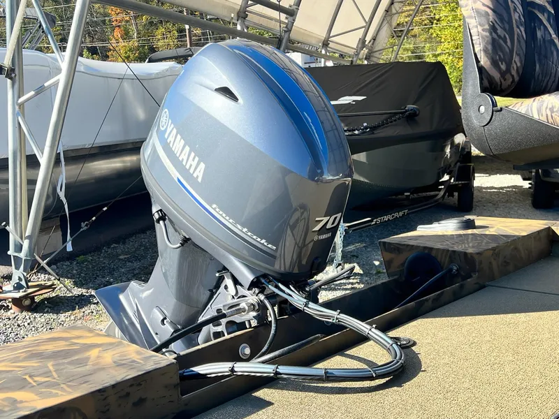 Slide: The Image of 2025 G3 Sportsman 1610 Vinyl with Yamaha 70 outboard motor in a boatyard. - 22