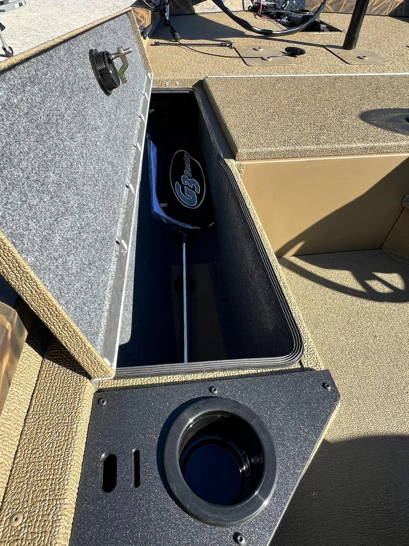 Slide: The Image of 2025 G3 Sportsman 1610 Vinyl boat storage compartment with cup holder. - 25