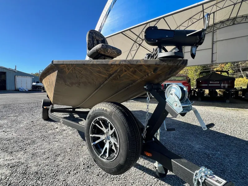 Slide: The Image of 2025 G3 Sportsman 1610 Vinyl boat on trailer, parked outdoors under clear blue sky. - 28