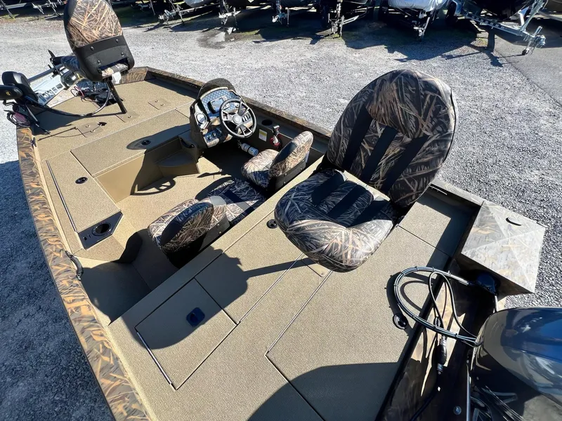 Slide: The Image of 2025 G3 Sportsman 1610 Vinyl boat interior with camo seats and steering console. - 35