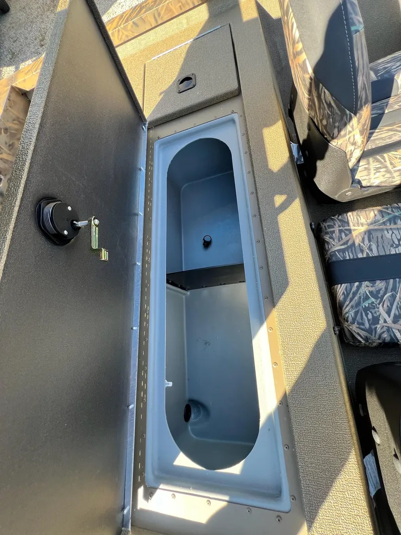 Slide: The Image of 2025 G3 Sportsman 1610 Vinyl boat interior storage compartment with camo seats. - 36