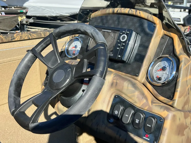 Slide: The Image of 2025 G3 Sportsman 1610 Vinyl boat dashboard with steering wheel and gauges. - 39