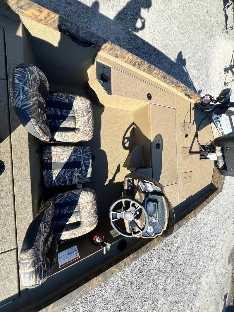 Slide: The Image of 2025 G3 Sportsman 1610 Vinyl boat interior with camo seats and steering console. - 4