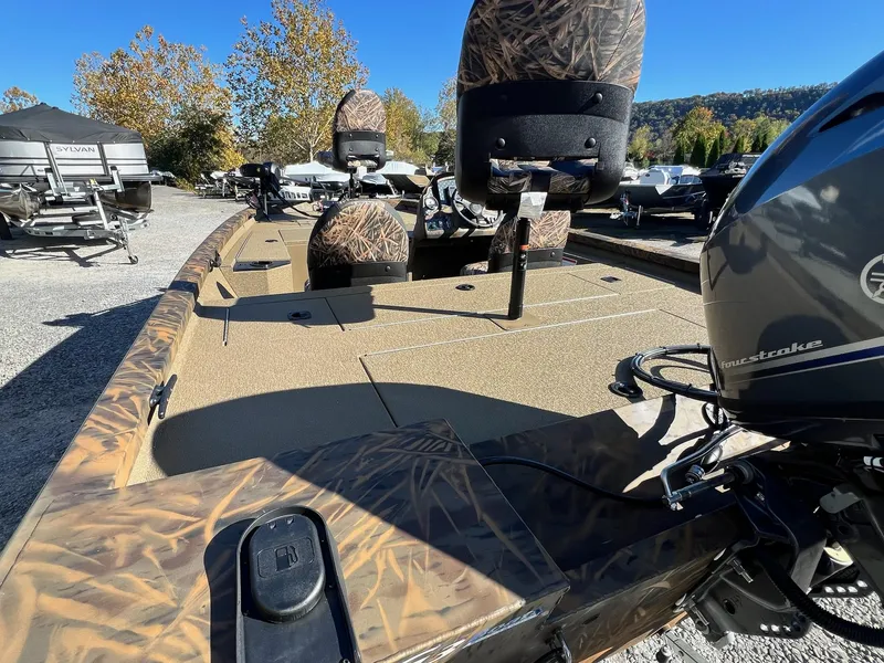 Slide: The Image of 2025 G3 Sportsman 1610 Vinyl boat with camo seats and four-stroke engine in outdoor setting. - 6