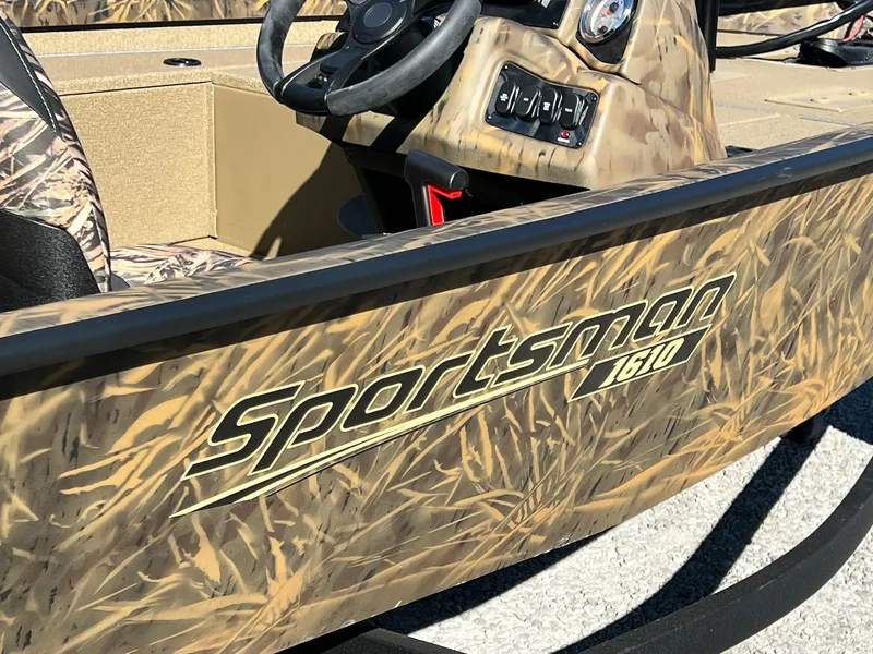 Slide: The Image of 2025 G3 Sportsman 1610 Vinyl boat with camouflage design and steering console. - 8