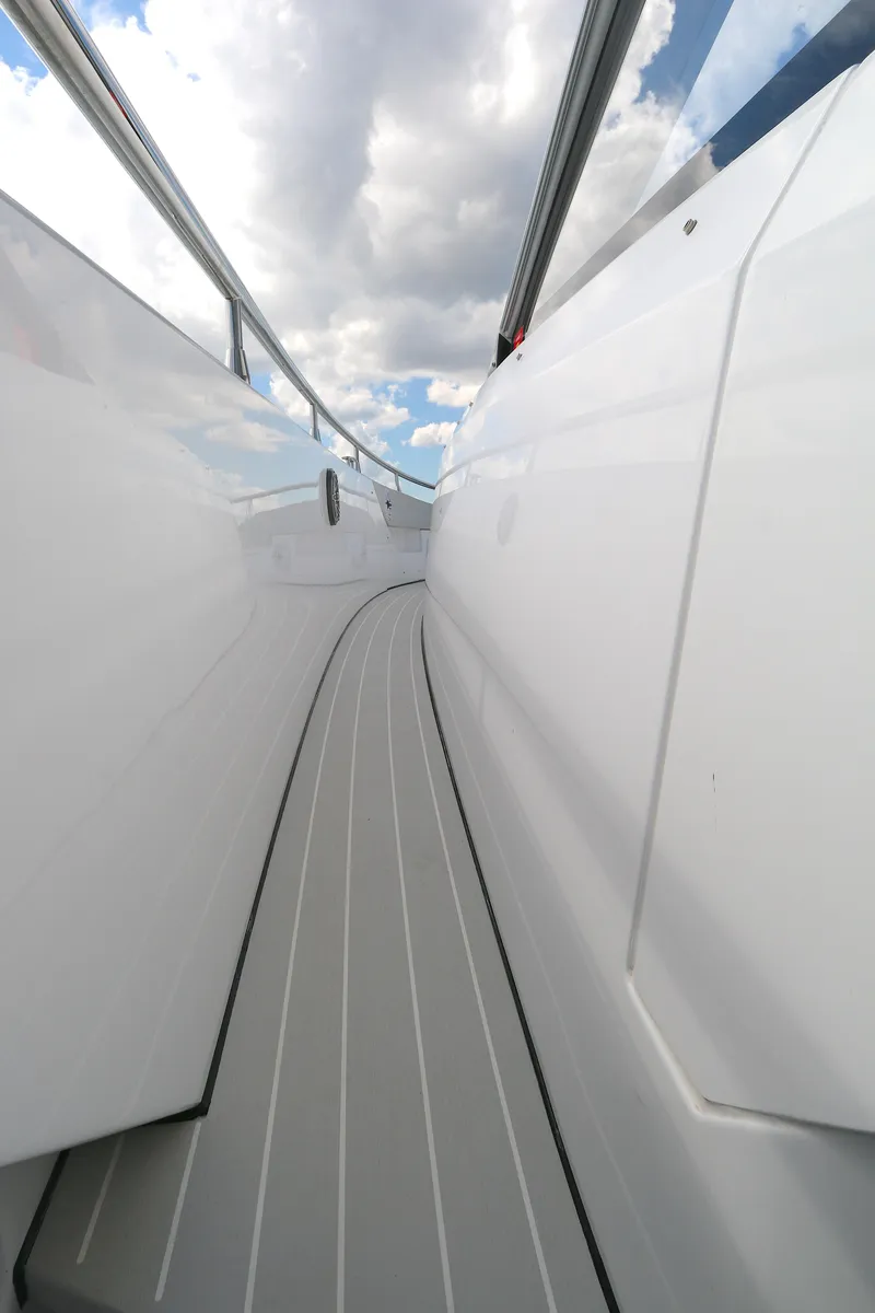 Slide: The Image of 2023 Azimut 47 VERVE yacht deck with sleek design and cloudy sky. - 12