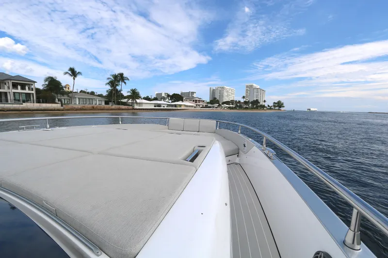 Slide: The Image of 2023 Azimut 47 VERVE yacht cruising near coastal cityscape under blue sky. - 14