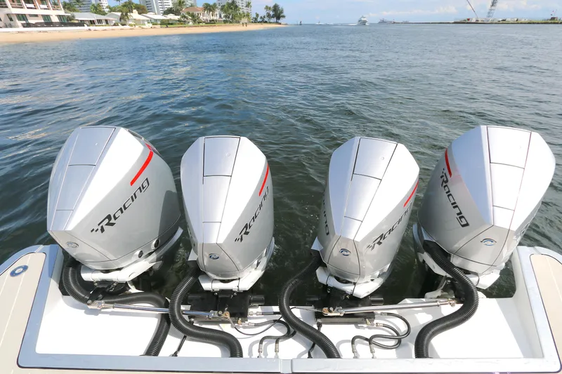 Slide: The Image of Four powerful outboard engines on a 2023 Azimut 47 VERVE yacht, docked by the shore. - 23