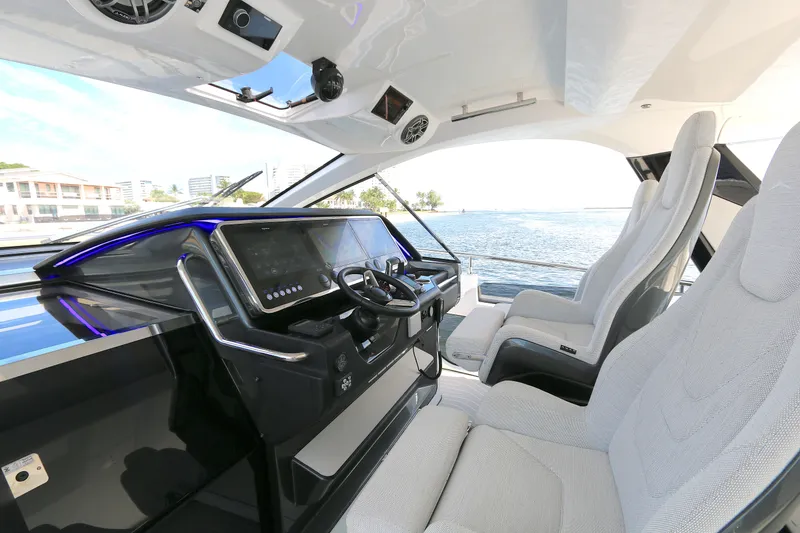 Slide: The Image of 2023 Azimut 47 VERVE yacht cockpit with modern controls and luxurious seating, overlooking the water. - 4