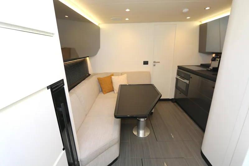 Slide: The Image of Interior of 2023 Azimut 47 VERVE yacht with modern kitchen and cozy seating area. - 6