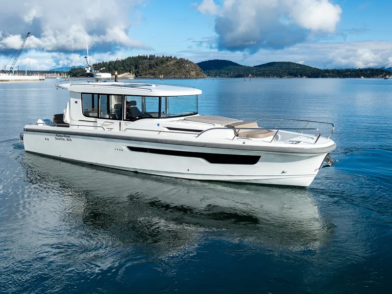 Slide: The Image of Nimbus C11 2021 boat cruising on a serene lake with scenic mountain backdrop. - 17