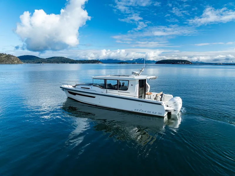 Slide: The Image of Nimbus C11 2021 boat cruising on a serene lake under a blue sky. - 20