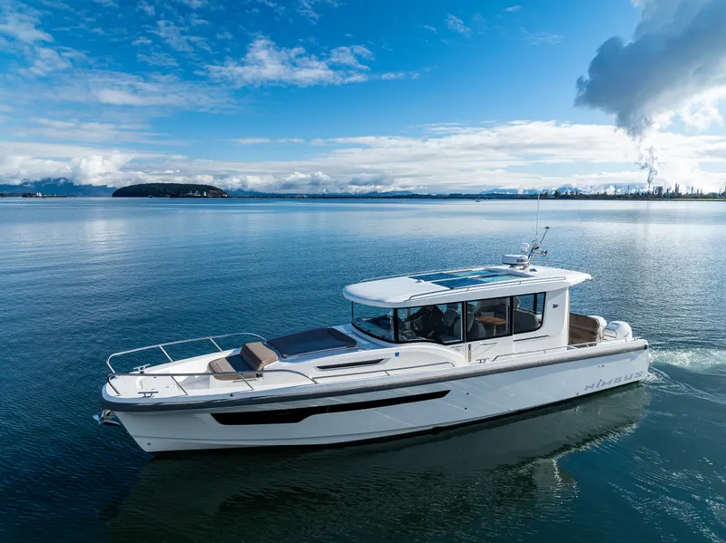 Slide: The Image of Nimbus C11 2021 boat cruising on a serene lake under a clear blue sky. - 21