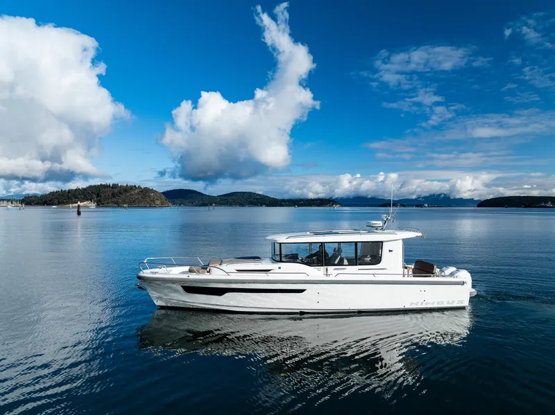 Slide: The Image of Nimbus C11 2021 boat cruising on a serene lake under a blue sky. - 22