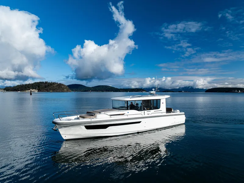 Slide: The Image of Nimbus C11 2021 boat cruising on a serene lake under a blue sky. - 23