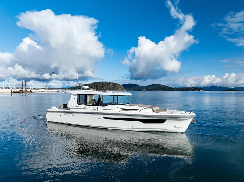 Slide: The Image of Nimbus C11 2021 boat cruising on a serene lake under a blue sky. - 28
