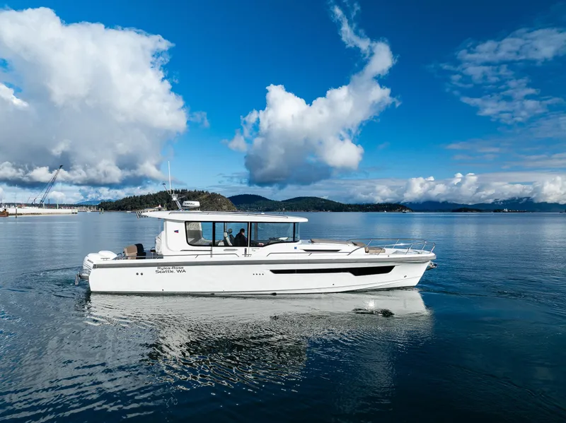 Slide: The Image of Nimbus C11 2021 boat cruising on a serene lake under a blue sky. - 29