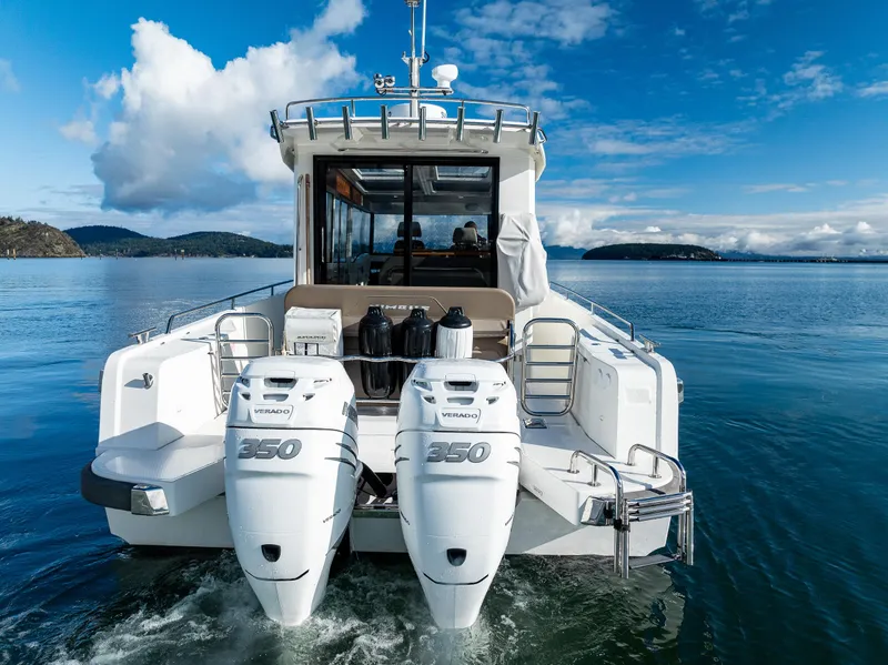 Slide: The Image of Nimbus C11 2021 boat with twin outboard engines on a serene lake. - 32