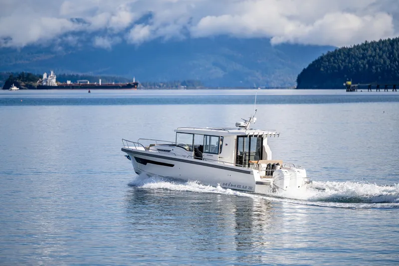 Slide: The Image of Nimbus C11 2021 boat cruising on a serene lake with mountains in the background. - 38