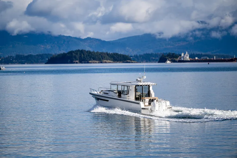 Slide: The Image of Nimbus C11 2021 boat cruising on a serene lake with mountainous backdrop. - 39