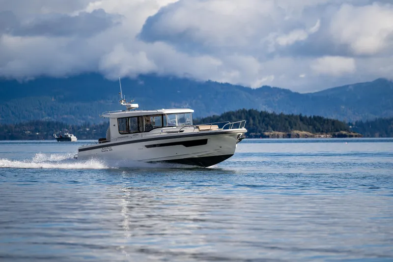 Slide: The Image of Nimbus C11 2021 boat cruising on a serene lake with mountainous backdrop. - 43