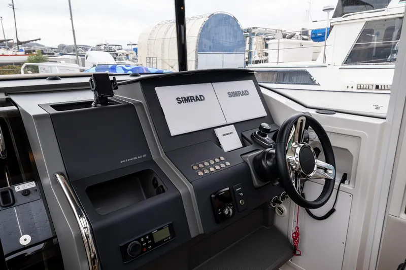 Slide: The Image of Nimbus C11 2021 boat dashboard with Simrad navigation system and steering wheel. - 6