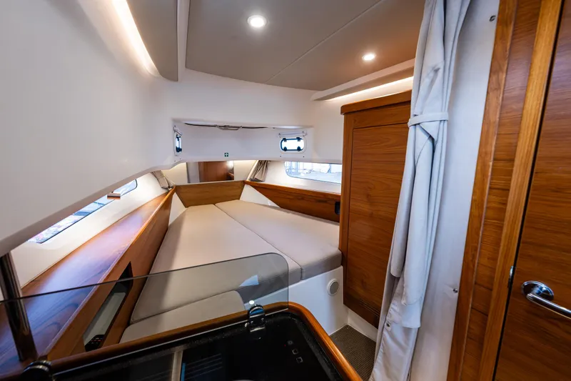 Slide: The Image of Luxurious cabin interior of 2021 Nimbus C11 yacht with wood accents and cozy bed. - 7