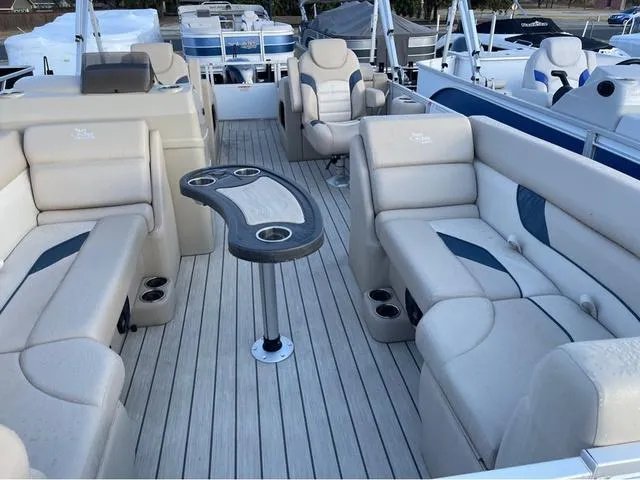 Slide: The Image of 2023 SunCatcher Select 22SS pontoon boat interior with beige seating and table. - 5