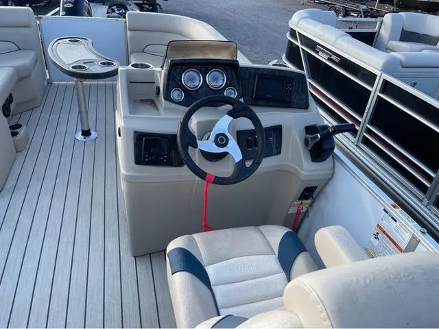 Slide: The Image of 2023 SunCatcher Select 22SS boat interior with steering console and seating. - 7