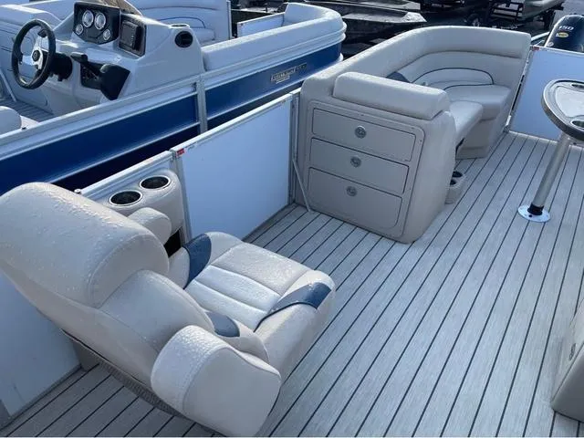 Slide: The Image of 2023 SunCatcher Select 22SS pontoon boat interior with plush seating and modern dashboard. - 8