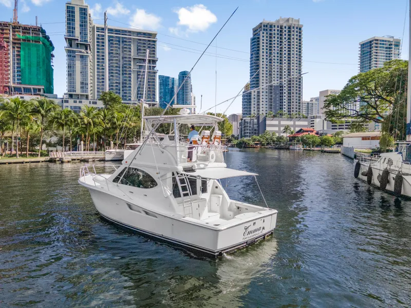 Slide: The Image of 2008 Tiara Yachts 3900 Convertible cruising in urban waterway with city skyline. - 14