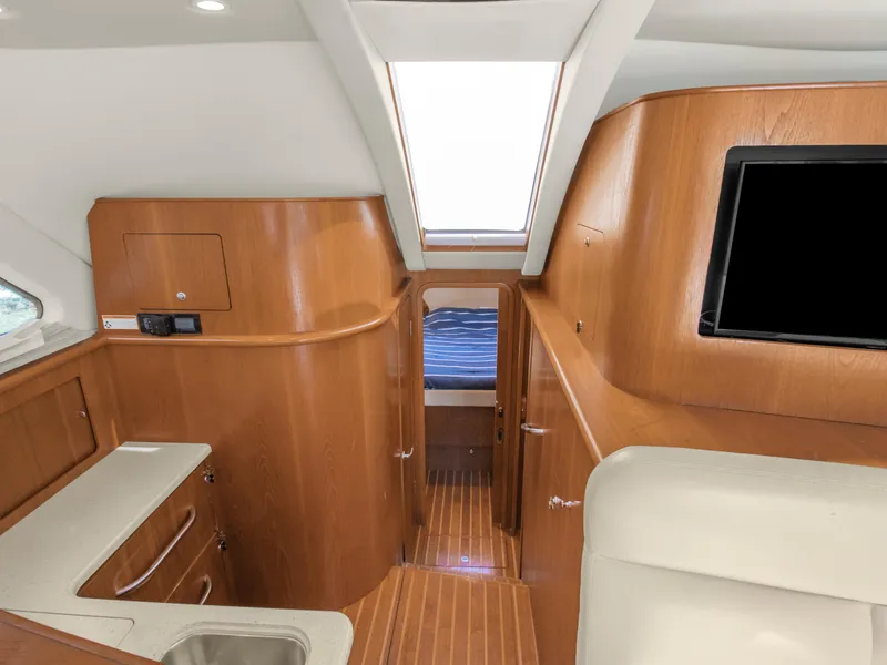 Slide: The Image of Interior of 2008 Tiara Yachts 3900 Convertible with wood finish and modern amenities. - 26