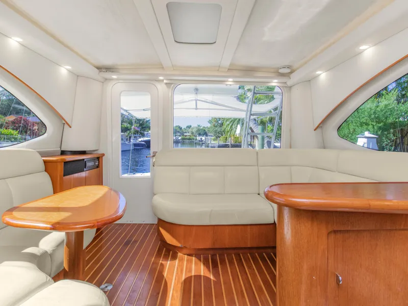 Slide: The Image of Interior of 2008 Tiara Yachts 3900 Convertible with elegant seating and wood finishes. - 28