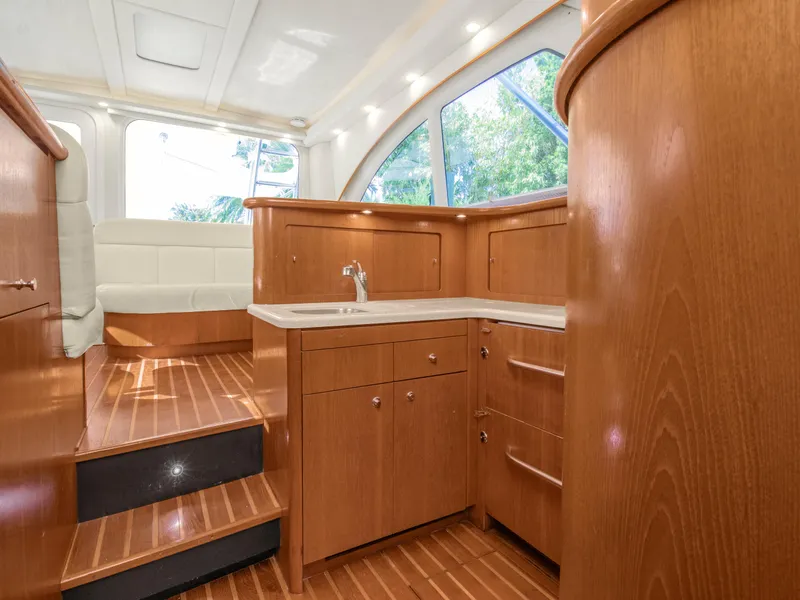 Slide: The Image of Interior of 2008 Tiara Yachts 3900 Convertible with wood cabinetry and seating. - 29