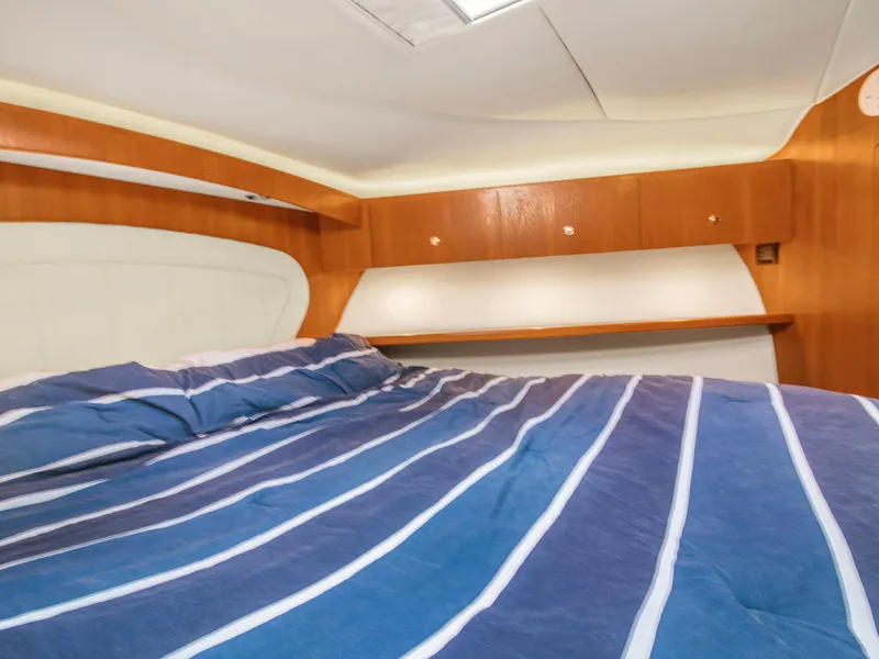 Slide: The Image of Interior cabin of 2008 Tiara Yachts 3900 Convertible with striped bedding. - 38