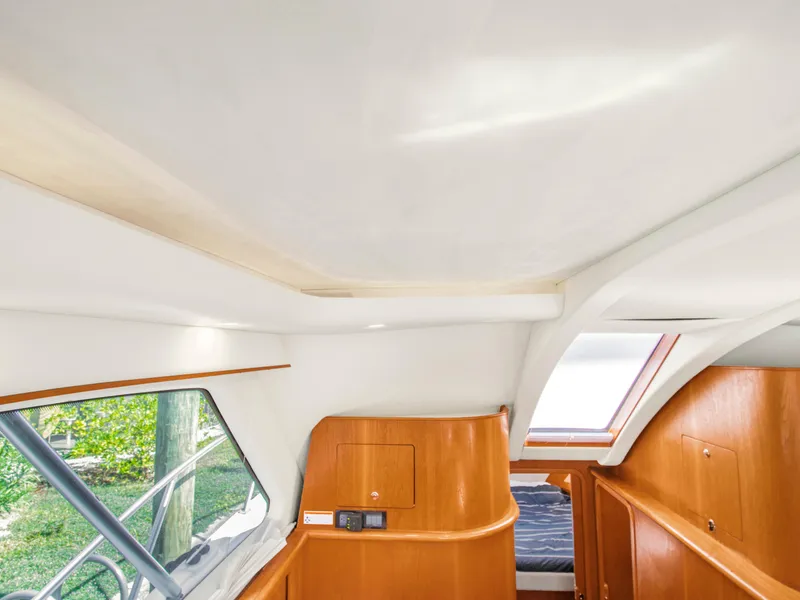 Slide: The Image of Interior of 2008 Tiara Yachts 3900 Convertible, featuring sleek wood finishes and natural light. - 39