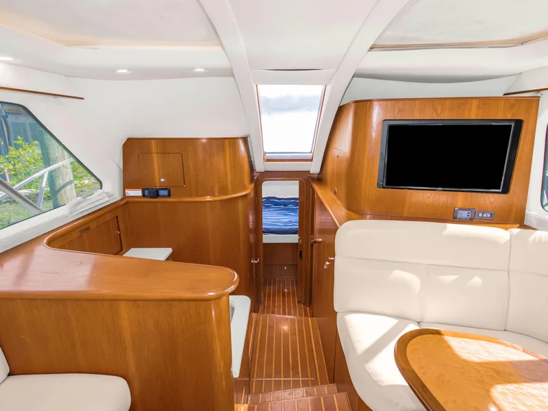 Slide: The Image of Luxurious interior of 2008 Tiara Yachts 3900 Convertible with wood finishes and seating area. - 40