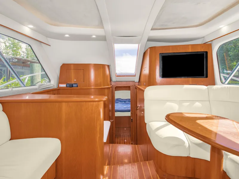 Slide: The Image of Luxurious interior of 2008 Tiara Yachts 3900 Convertible with wood finishes and plush seating. - 41