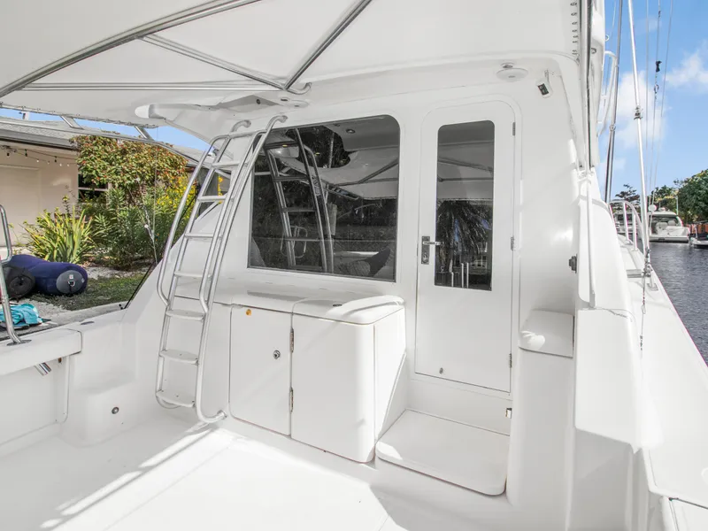 Slide: The Image of 2008 Tiara Yachts 3900 Convertible, white exterior, docked with ladder and door access. - 46