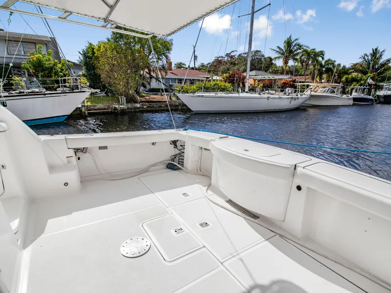 Slide: The Image of 2008 Tiara Yachts 3900 Convertible boat deck, docked near waterfront homes and sailboats. - 48