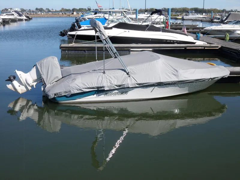 The Image of 1992 Rinker Captiva 170 OB boat covered at marina dock. - 1