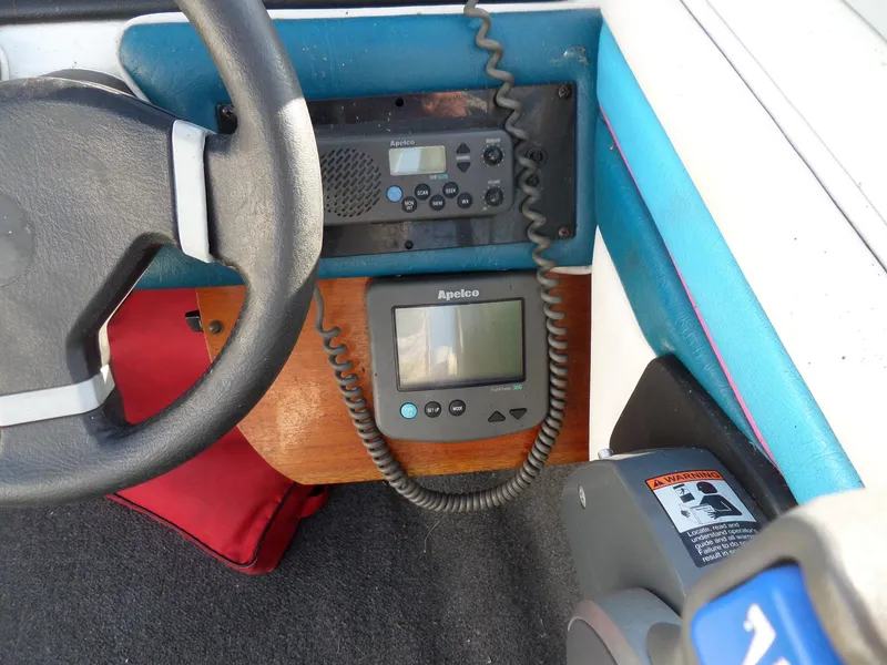 Slide: The Image of 1992 Rinker Captiva 170 OB dashboard with steering wheel, radio, and navigation equipment. - 11