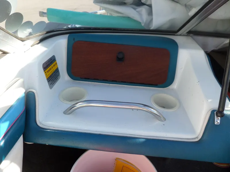 Slide: The Image of Interior of 1992 Rinker Captiva 170 OB boat with cup holders and storage compartment. - 12