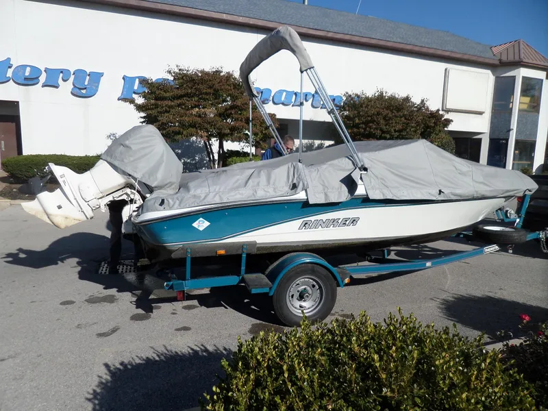 Slide: The Image of 1992 Rinker Captiva 170 OB boat on trailer, covered and parked outdoors. - 15