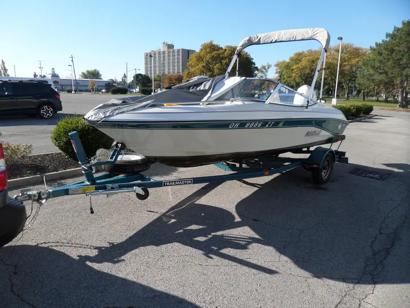 Slide: The Image of 1992 Rinker Captiva 170 OB boat on trailer in parking lot. - 3