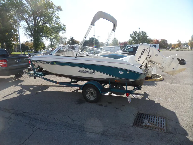 Slide: The Image of 1992 Rinker Captiva 170 OB boat on trailer in parking lot. - 4