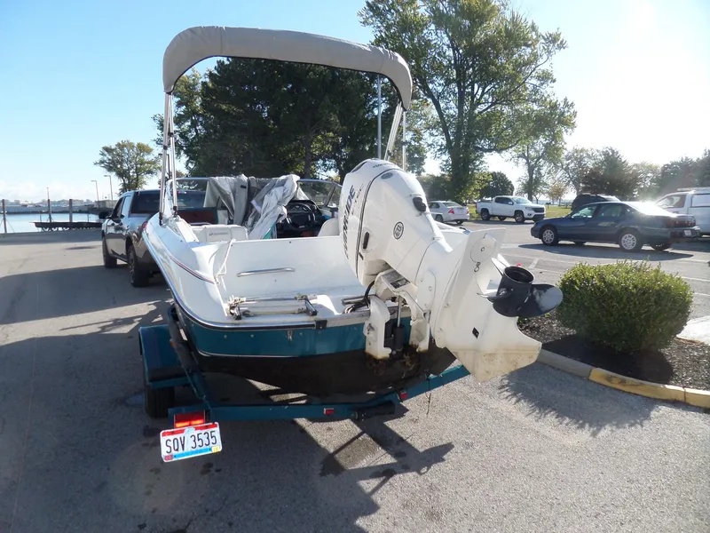 Slide: The Image of 1992 Rinker Captiva 170 OB boat on trailer in parking lot. - 5