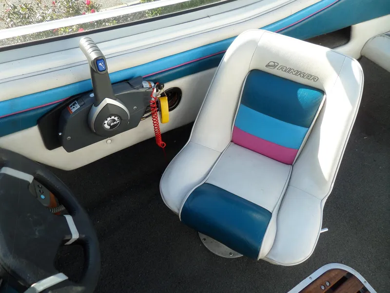 Slide: The Image of Interior of 1992 Rinker Captiva 170 OB boat with colorful seat and control panel. - 8