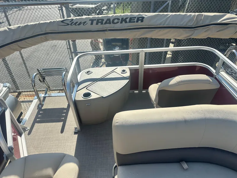 Slide: The Image of 2025 Sun Tracker Bass Buggy 18 DLX pontoon boat interior with seating and storage. - 3