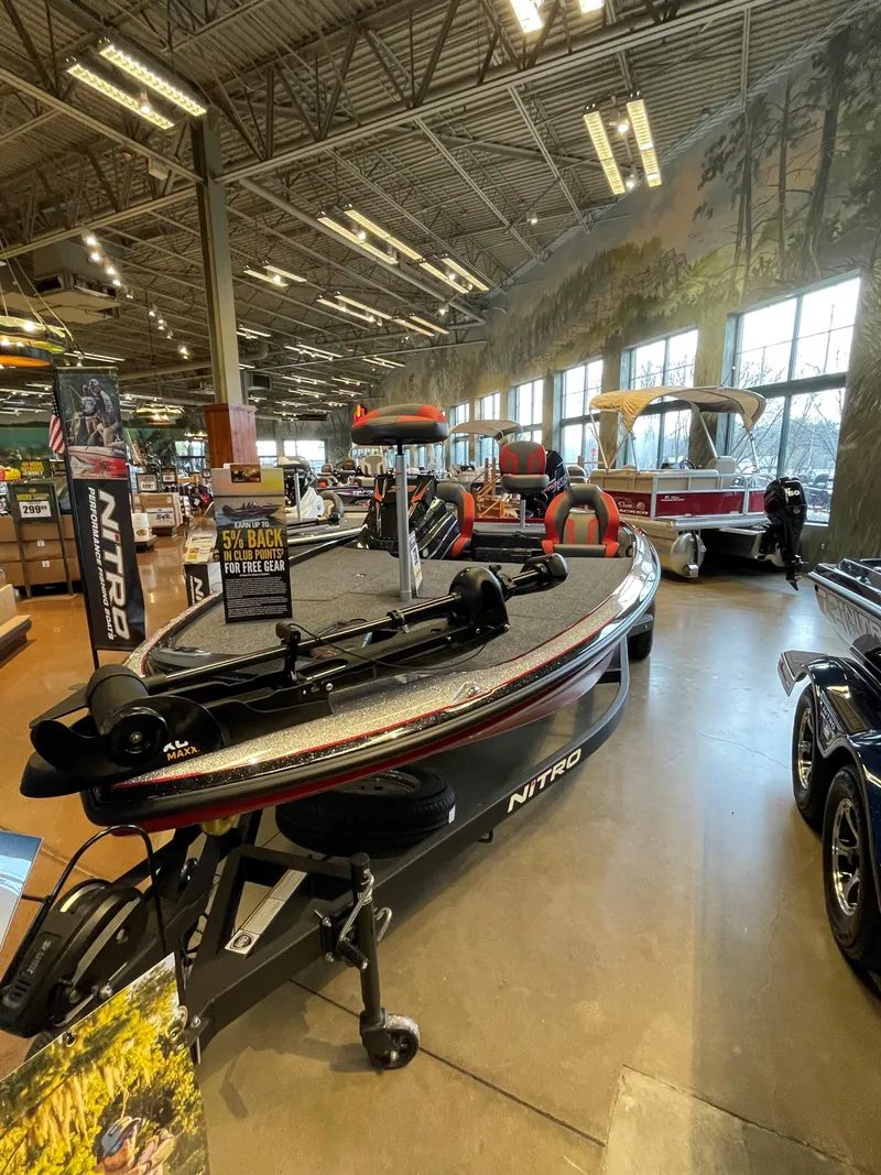 Slide: The Image of 2025 Nitro Z19 boat displayed indoors with fishing equipment. - 1